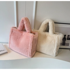 Detail view of pink and off-white plush tote bags with dense faux fur texture