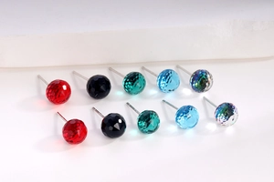 Detail of S925 silver stud earrings with multi-color faceted crystal balls in various shades