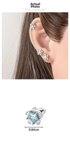 Macro detail of star titanium steel earrings in blue, pink and white with 0.84cm size mark
