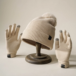 Winter knit set with beige beanie, faux fur pompom, and touch screen gloves for warmth