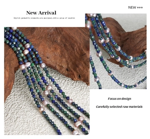 Detailed close-up of blue faceted stones and irregular pink pearls on a layered necklace