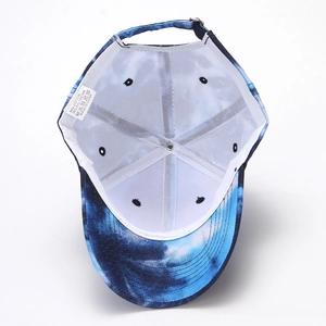 Detail view of tie-dye baseball cap interior showing 80% cotton material and stitching