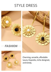 Detail of gold flower jewelry set featuring sunburst petals and pearls on a sleek snake chain