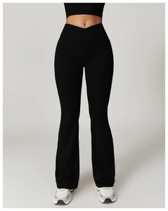 Detail of high waisted cross waist design on black flare yoga pants for women
