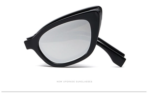 Detail view of foldable cat-eye sunglasses with black frame and silver mirrored lenses