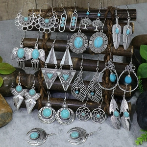Detailed set of 12 bohemian earrings featuring turquoise stones and silver feather charms