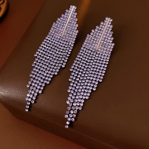 Detail of purple rhinestone tassel earrings with a cascading silver-tone setting