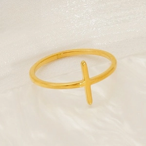 Detailed view of a minimalist golden leaf ring with a vertical bar design on satin fabric
