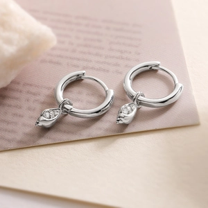 Silver geometric earrings with teardrop zircons on decorative stones, elegant style