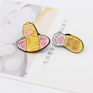 Detail of creative enamel cat paw pins with Paw ty and Bye Bye artistic lettering