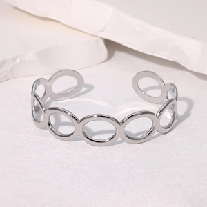 Detailed macro view of geometric hollow link structure on silver polished bangle