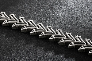 Macro view of punk style silver steel bracelet with V-shaped links and matte finish
