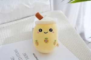 Detailed plush bubble tea keychain with yellow pineapple embroidery and smiling face