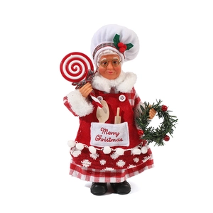 Standing Mrs. Claus chef figurine with Christmas wreath and lollipop decor