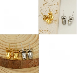 Close-up of polished gold and silver tulip earrings displayed on natural stone