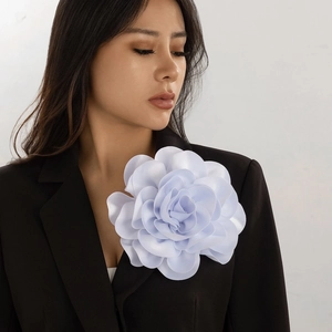 Elegant white satin 3D flower brooch pin worn on a black blazer for a chic look