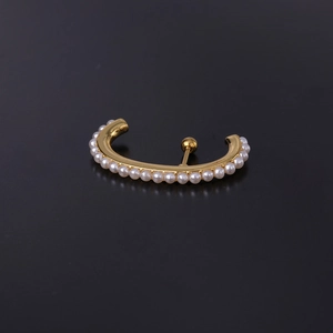 Curved gold stud earring with faux pearls on a black matte background