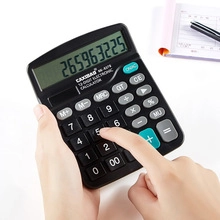 Close-up of a 12-digit electronic calculator being used in an office desktop setting