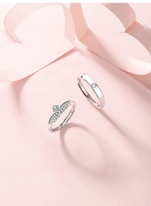 Detail of S925 sterling silver couple rings showing angel wing texture and S925 hallmark