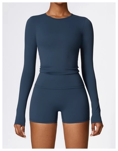 Detail of high-stretch navy long sleeve yoga top and high-waist sports shorts