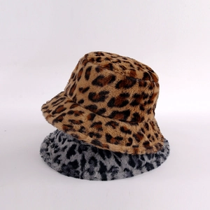 Detail showing two plush leopard print bucket hats in brown and gray stacked on white