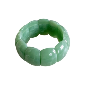 Green acrylic geometric stretch bracelet with marble texture in a minimalist fashion style