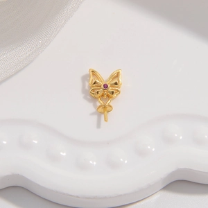 Detailed view of a golden butterfly pendant base with inlaid purple zircon for DIY jewelry
