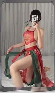 Detailed view of red silk halter top with golden floral embroidery and sheer long skirt