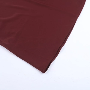 Detailed close-up showing precision hem stitching on the burgundy satin evening dress fabric