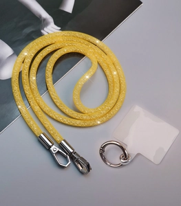 Detail of yellow mesh rhinestone phone lanyard with silver clasps and transparent patch