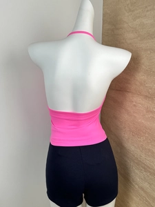 Rear view of pink halter neck top with open back design and elastic knit fabric texture