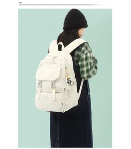 Creamy white high capacity backpack with functional multi-pockets shown on model back