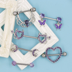 Purple zircon heart and butterfly nipple rings set on a white vintage frame background