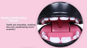 Macro detail of interactive money box showing pink mouth and white simulation teeth