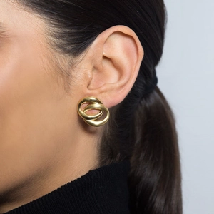 Close-up of model wearing 18K gold double hoop oval earrings with polished finish