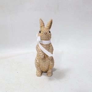 Detail of resin rabbit statue with woven texture and a white silk bow for garden decor