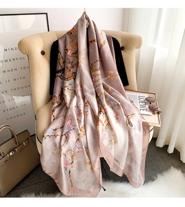 Detailed drape of pink silk scarf with floral print over a white armchair