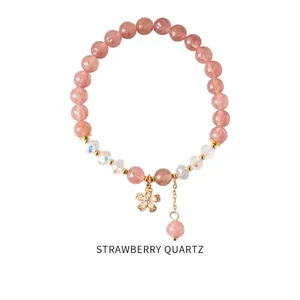 Bracciale in cristallo fragola e perle iridescenti con pendente a fiore d'oro