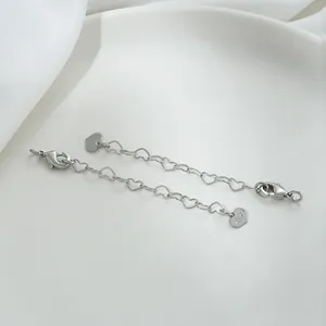 Close-up of heart-shaped link extender chain with lobster clasp and Love heart pendant