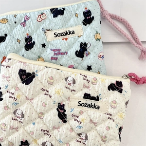 Close-up of quilted cotton pouches with cute cat patterns and pink woven lanyards