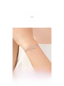 Close-up of a double-layered S925 sterling silver bracelet featuring a small round diamond