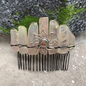 Detailed view of bohemian crystal hair comb with black wire wrap and silver sun charm