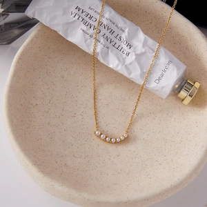 Elegant 18K gold plated stainless steel pearl necklace in a ceramic bowl setting