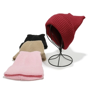 Detail showing knit texture and cat ear design in pink, khaki, black and red bean colors