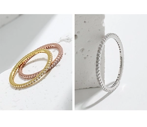 Detail of S925 sterling silver eternity rings with cubic zirconia in three metal colors