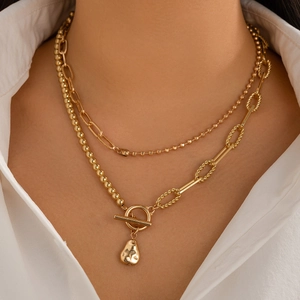Double-layered gold necklace with beaded chains, OT buckle and irregular drop pendant