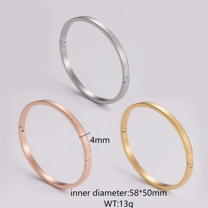 Detail of 4mm stainless steel bangles featuring micro checkered pattern in three colors