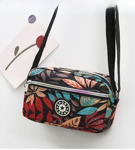 Detail of colorful leaf pattern oxford shoulder bag with multi-zipper compartments