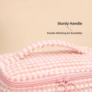 Close-up of pink checkered plush makeup bag with sturdy handles and double stitching