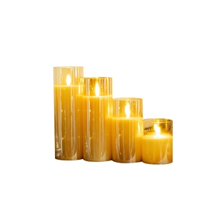 Set of four amber glass LED flameless candles with warm flickering flame effect